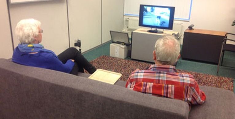 Elderly man and woman watching tv