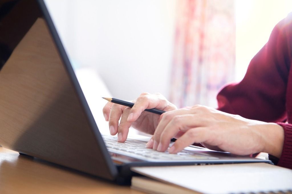 hands typing laptop