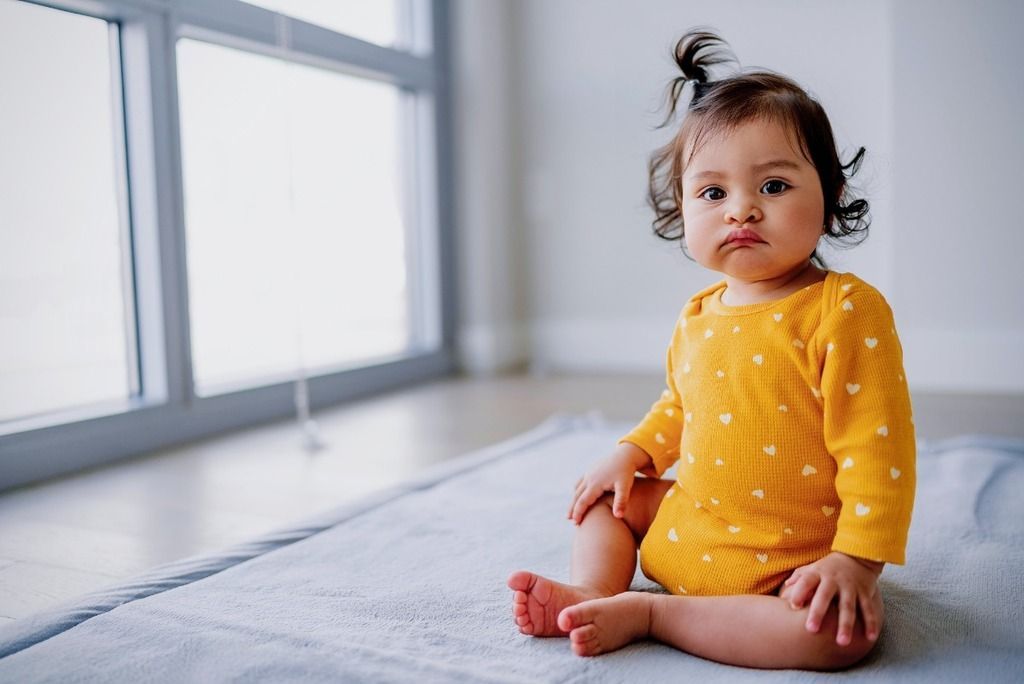 infant baby girl frowning