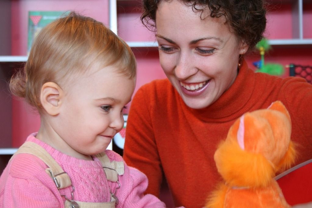 mother and child playing with stuffed animal