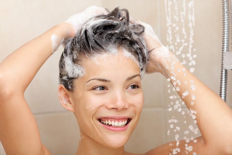 woman in shower washing hair shampoo