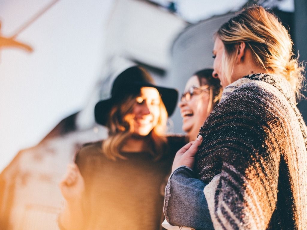 women meeting and laughing outside