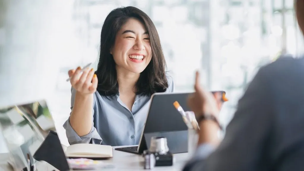 Woman working on laptop using FaceReader