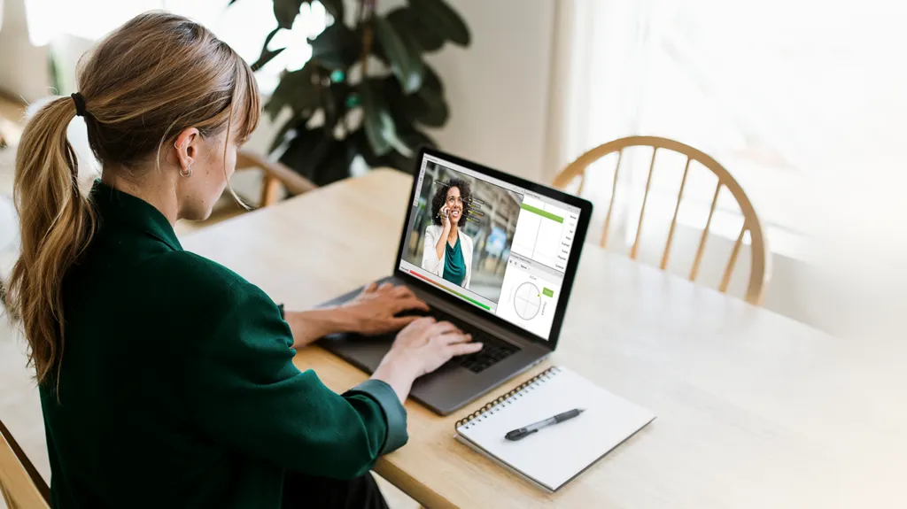 Woman working with FaceReader on laptop at home