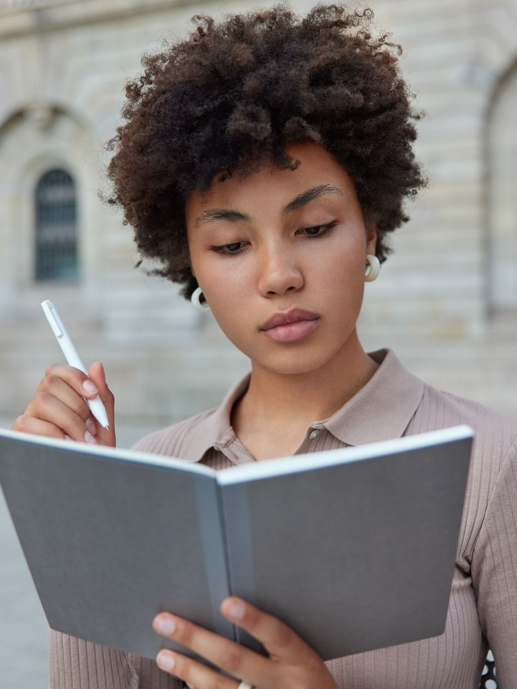Woman with notebook thinking