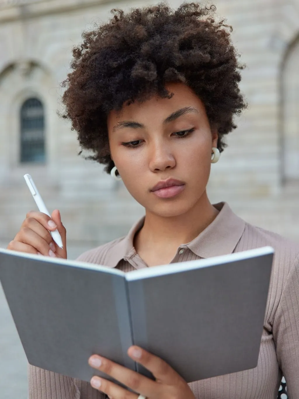 Woman with notebook thinking